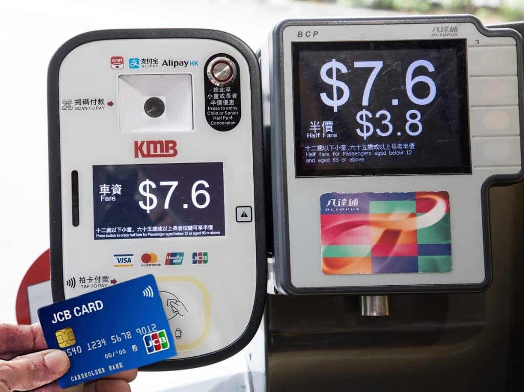 JCB card being tapped on reader on board Kowloon Motor Bus, next to Octopus reader